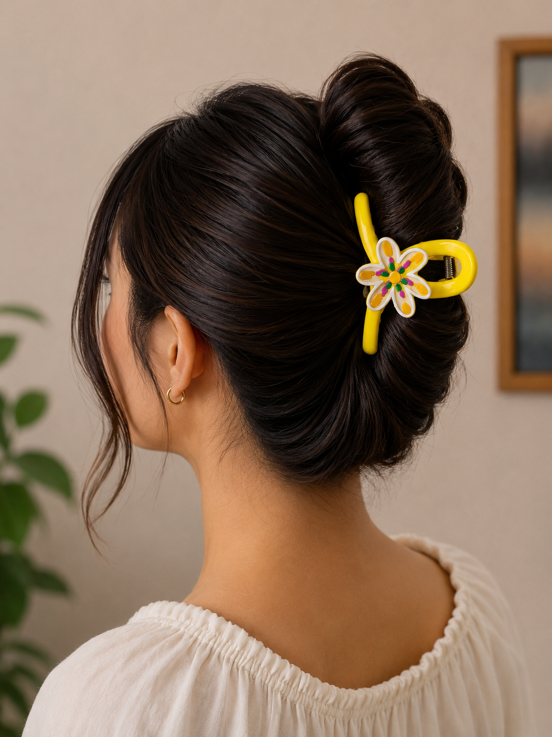 Stylish yellow claw clip with colorful floral charm.